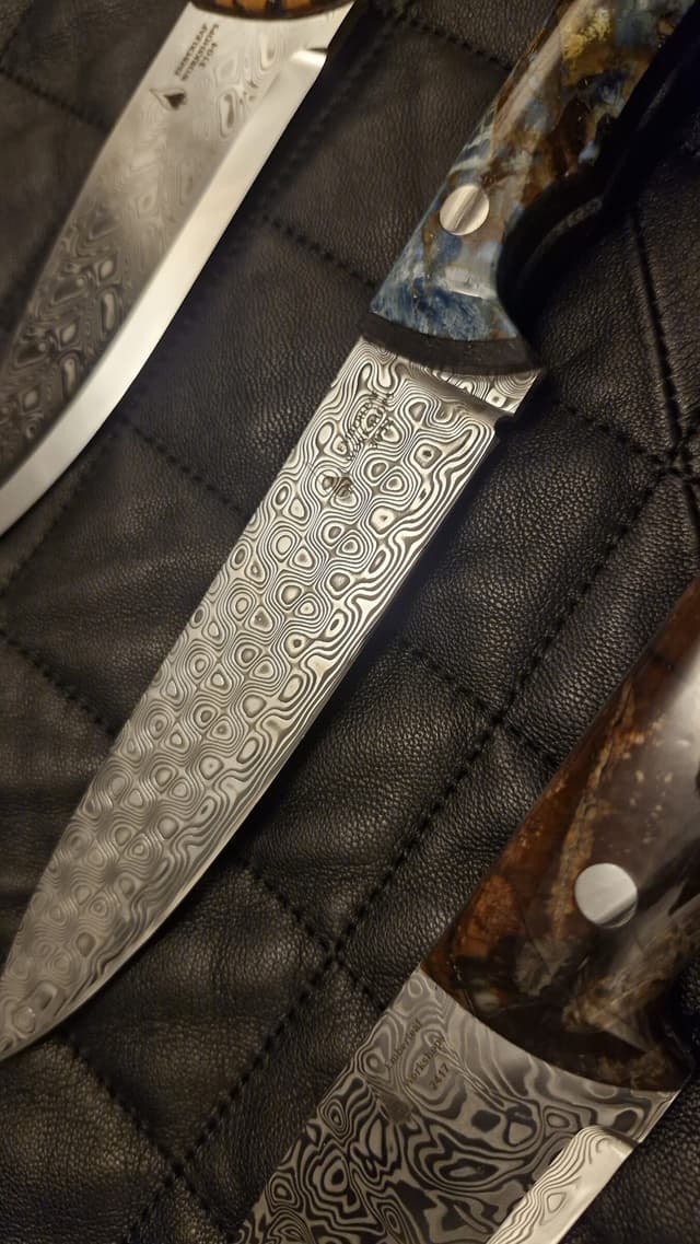 A Damascus blade with a blue and gold stabilised handle