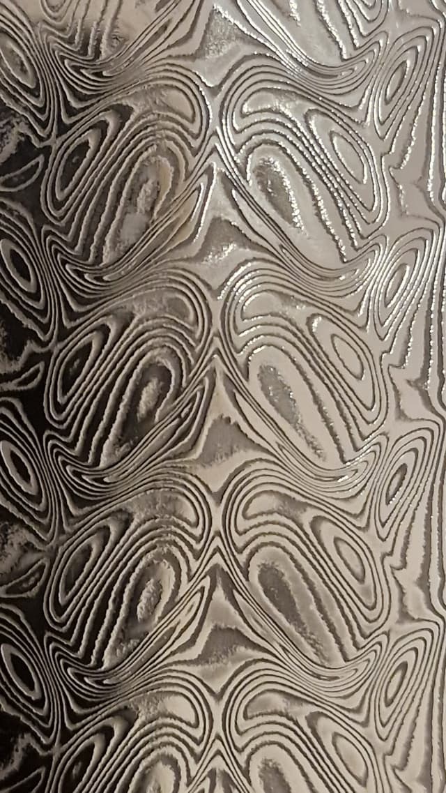Macro photograph of a Damascus billet showing its layered pattern