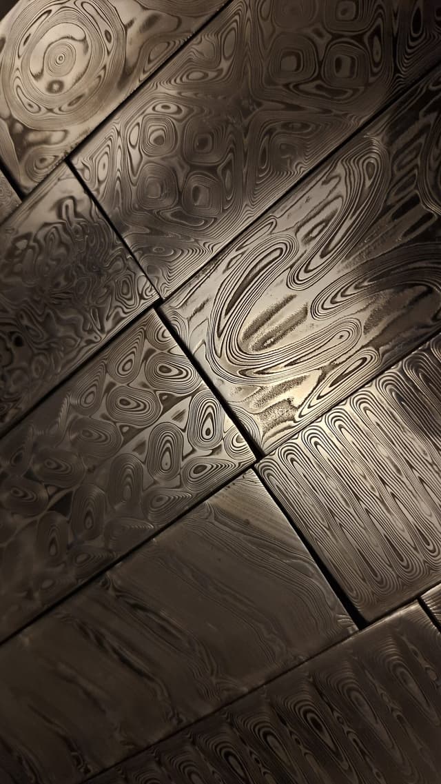 Damascus billets with different patterns in a grid