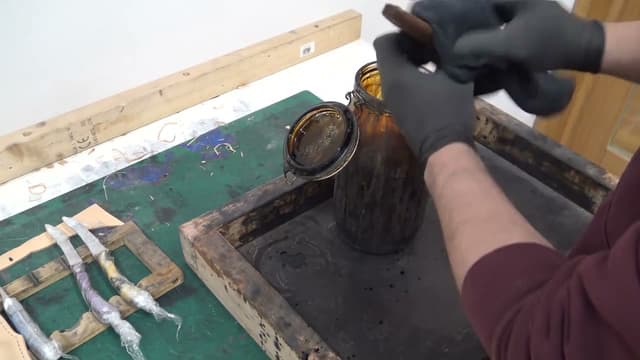 Sheath leather being dyed at the bench