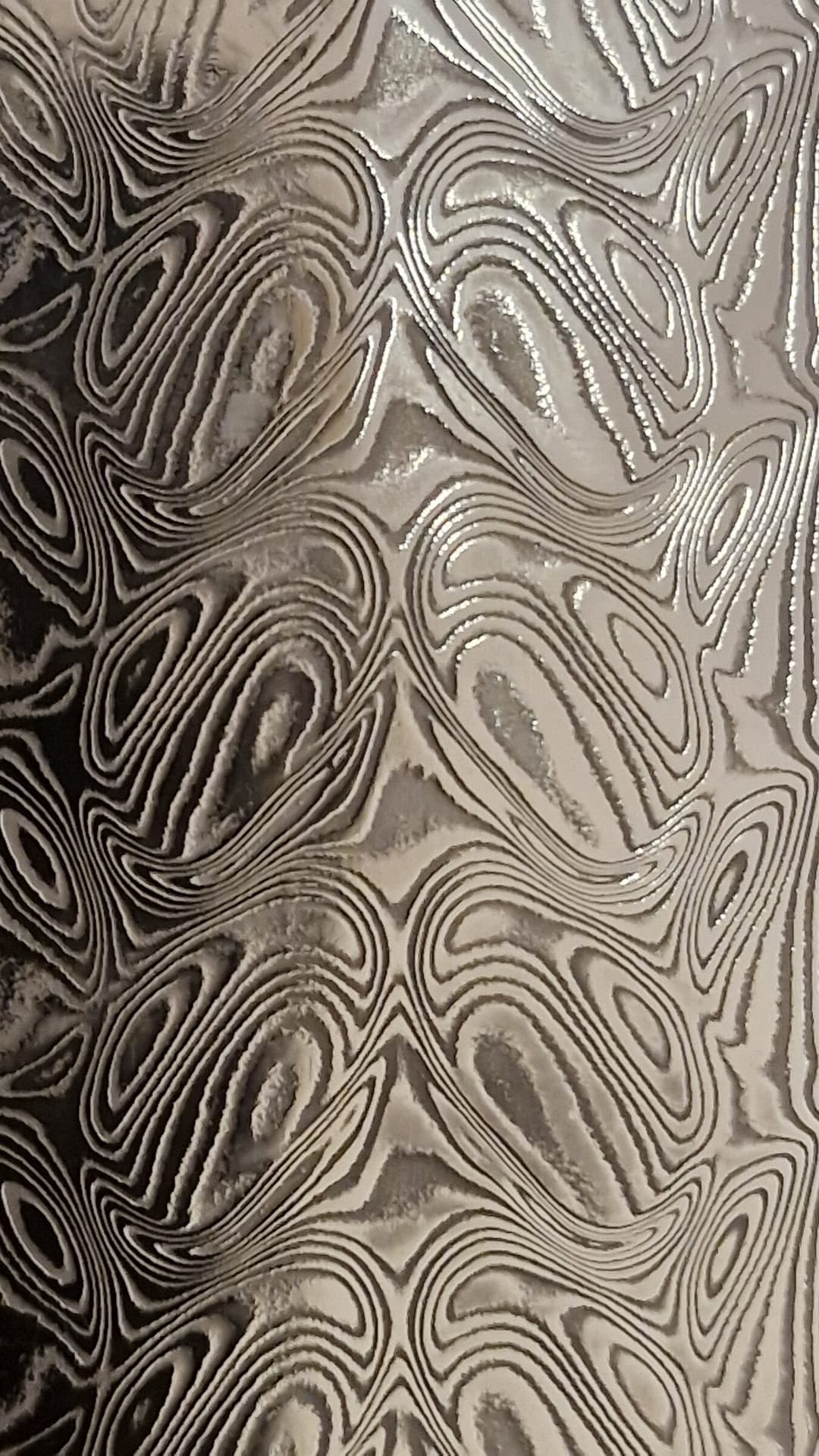 Extreme macro of an etched damascus steel surface pattern