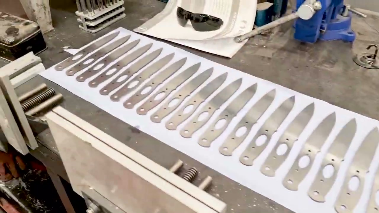 A batch of blade blanks laid out fresh from heat treatment