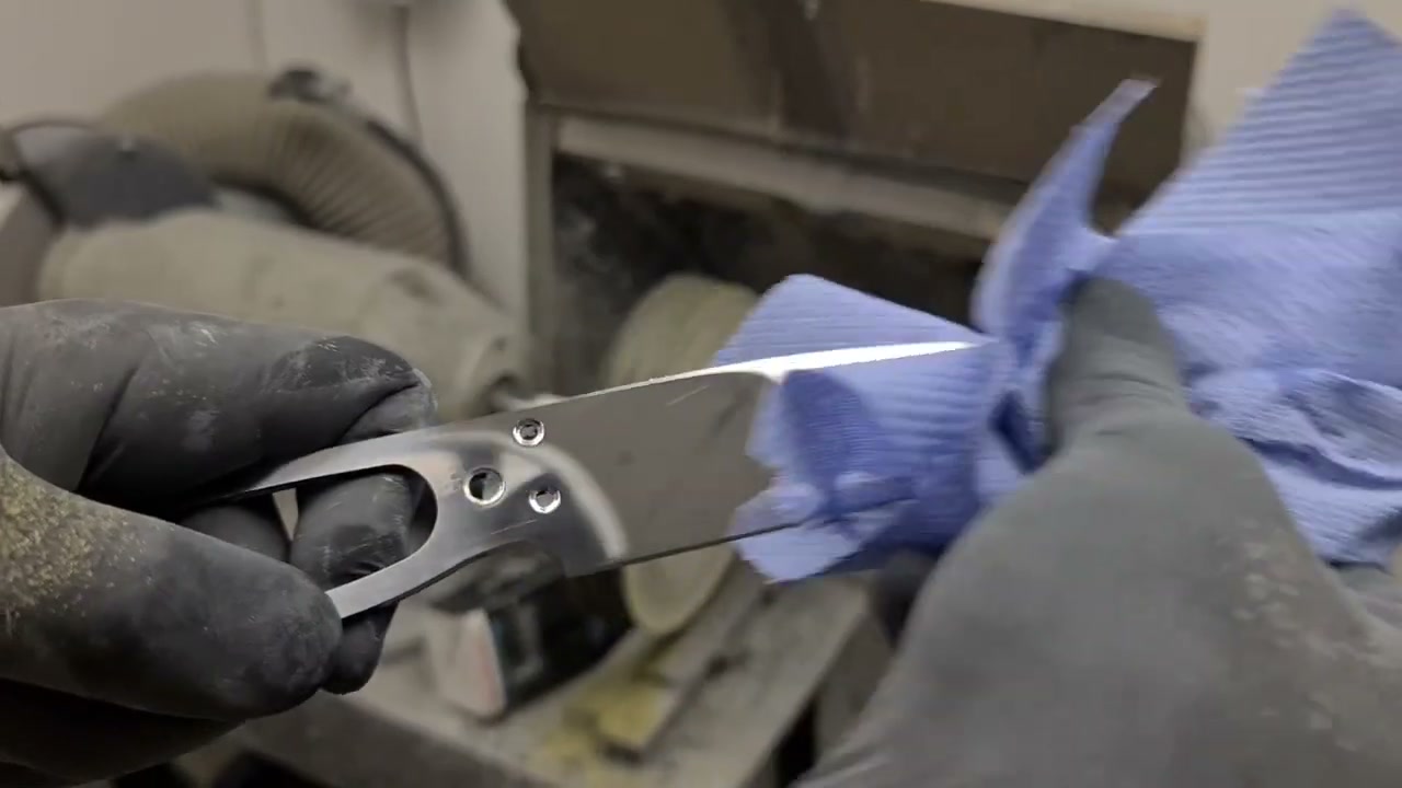 A blade being polished to a mirror finish with a cloth